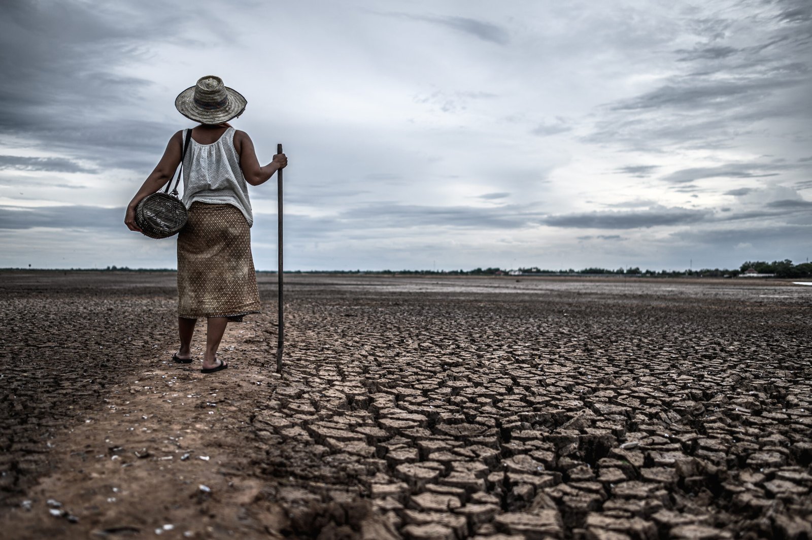 women standing on dry soil and fishing gear, global warming and